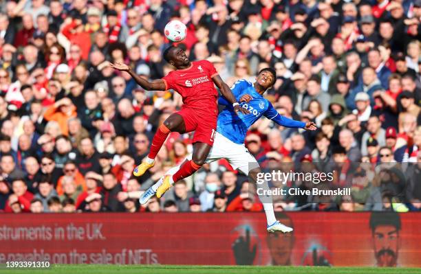 Sadio Mane of Liverpool jumps for the ball with Demarai Gray of Everton during the Premier League match between Liverpool and Everton at Anfield on...