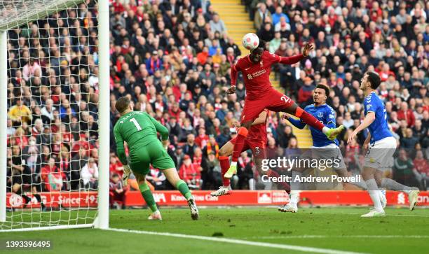 Divock Origi of Liverpool scores the second goal making the score 2-0 during the Premier League match between Liverpool and Everton at Anfield on...