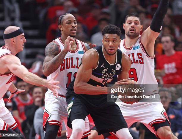 Giannis Antetokounmpo of the Milwaukee Bucks looks to move against Alex Caruso, DeMar DeRozan and Nikola Vucevic of the Chicago Bulls during Game...