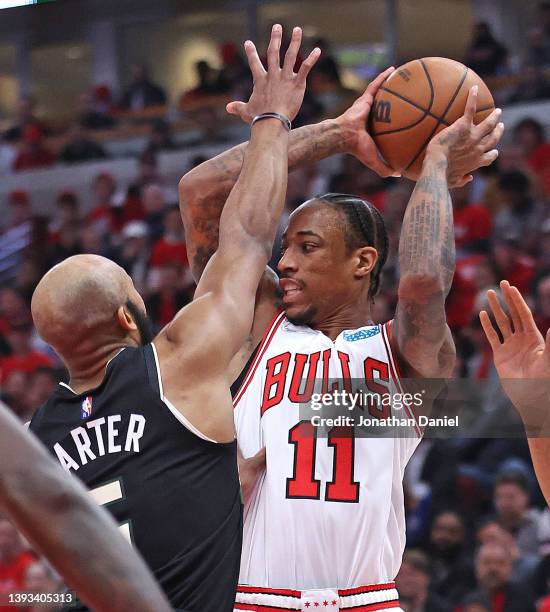 DeMar DeRozan of the Chicago Bulls leaps to pass against Jevon Carter of the Milwaukee Bucks during Game Four of the Eastern Conference First Round...