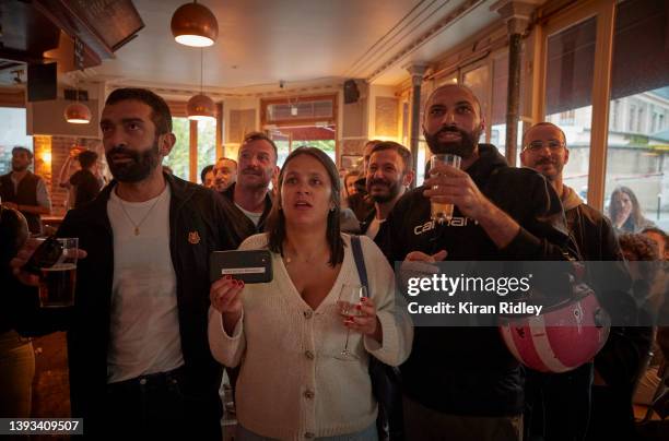 Parisians wait to see the result of the French Presidential Election in Le Carillon, a scene of the November 13th terrorist attacks, on April 24,...