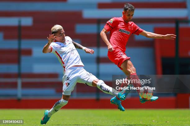 Luis Reyes of Atlas fights for the ball with Raul Lopez of Toluca during the 16th round match between Toluca and Atlas as part of the Torneo Grita...