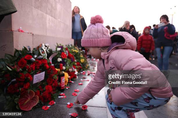 People lay poppies on the cenotaph to commemorate Anzac Day during the dawn service at Auckland War Memorial Museum on April 25, 2022 in Auckland,...