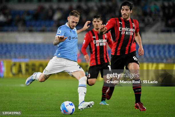 Manuel Lazzari of SS Lazio compete for the ball with Sandro Tonali of AC MIlan during the Serie A match between SS Lazio and AC Milan at Stadio...