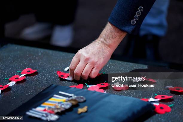 Poppy is placed on the Tomb of the Unknown Warrior during Anzac Day dawn service at Pukeahu National War Memorial Park on April 25, 2022 in...