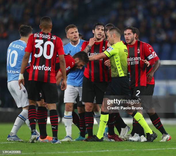 Davide Calabria and Sandro Tonali of AC Milan and Ciro Immobile of SS Lazio confront referee Marco Guida during the Serie A match between SS Lazio...