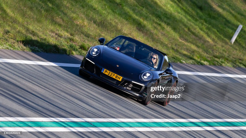 Dutch black 2017 Porsche 911 Carrera 4 GTS driving on the N36