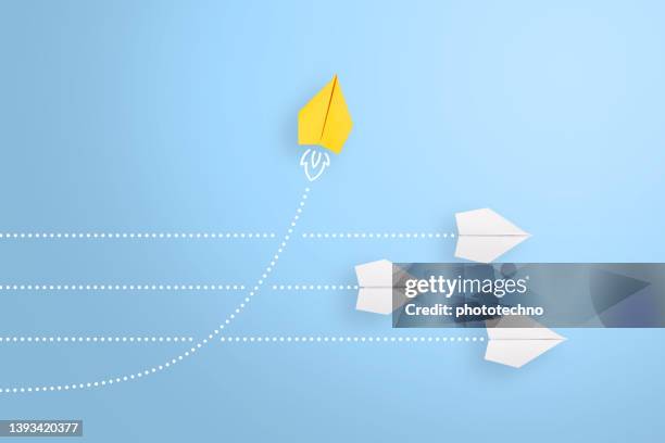 change concepts with yellow paper airplane leading among white - initiative stock pictures, royalty-free photos & images