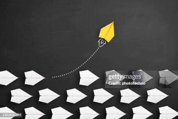 change concepts with yellow paper airplane leading among white - initiative stock pictures, royalty-free photos & images