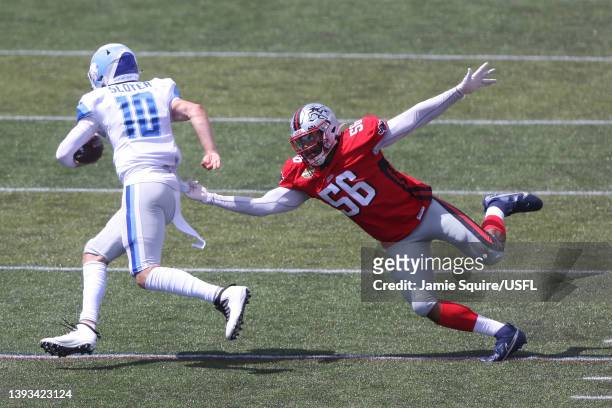 Kyle Sloter of New Orleans Breakers runs with the ball as Travis Feeney of Tampa Bay Bandits defends in the first quarter of the game at Protective...