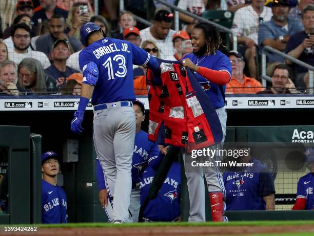 Vladimir Guerrero Jr. #27 of the Toronto Blue Jays celebrates with Lourdes Gurriel Jr. #13 after a home run in the fifth inning against the Houston...