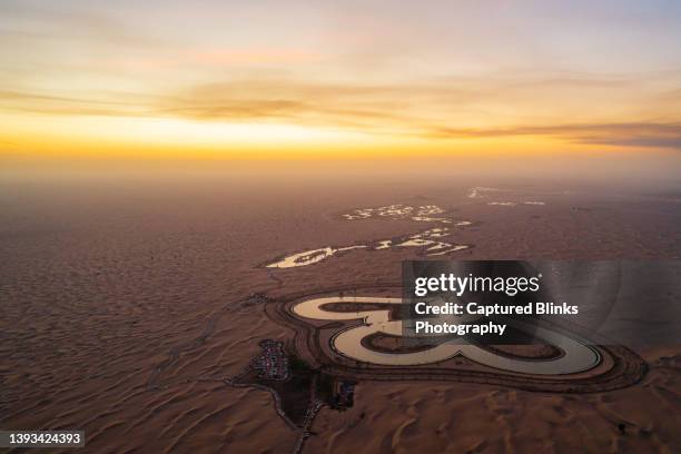 aerial view of a man-made heart shaped "love lake" in the dubai desert, uae - dubai park stock pictures, royalty-free photos & images