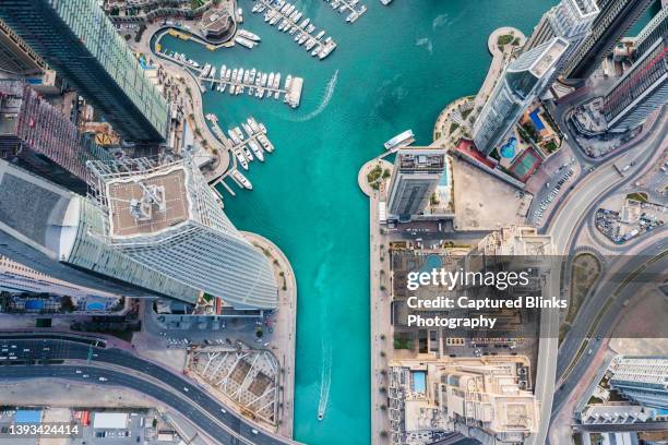 aerial view of dubai marina futuristic skyline with man made lake in the middle - dubai metro stockfoto's en -beelden