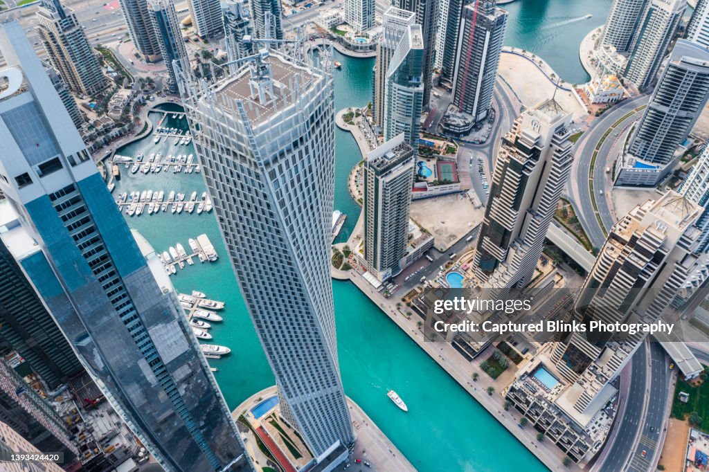 Aerial view of Dubai Marina futuristic skyline with man made lake in the middle