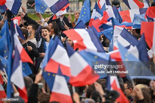 Macron supporters react at Champs de Mars as they find out the result of the French presidential election on April 24, 2022 in Paris, France....