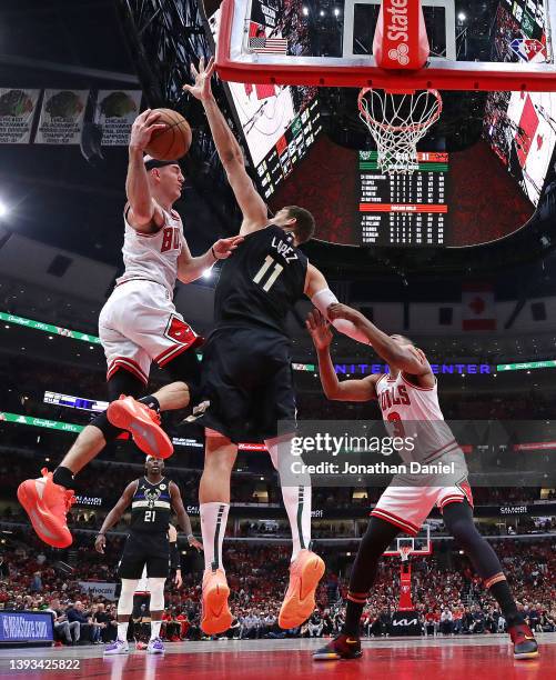 Alex Caruso of the Chicago Bulls leaps to shoot over Brook Lopez of the Milwaukee Bucks during Game Four of the Eastern Conference First Round...