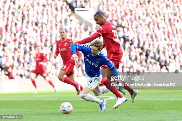 Anthony Gordon of Everton is bundled over by Joel Matip during the Premier League match between Liverpool and Everton at Anfield on April 24, 2022 in...