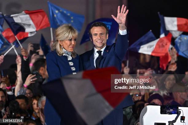 France's centrist incumbent president Emmanuel Macron stands with his wife Brigitte Macron after he beats his far-right rival Marine Le Pen for a...