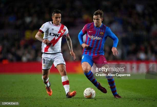 Oscar Trejo of Rayo Vallecano battles for possession with Nico Gonzalez of FC Barcelona during the LaLiga Santander match between FC Barcelona and...