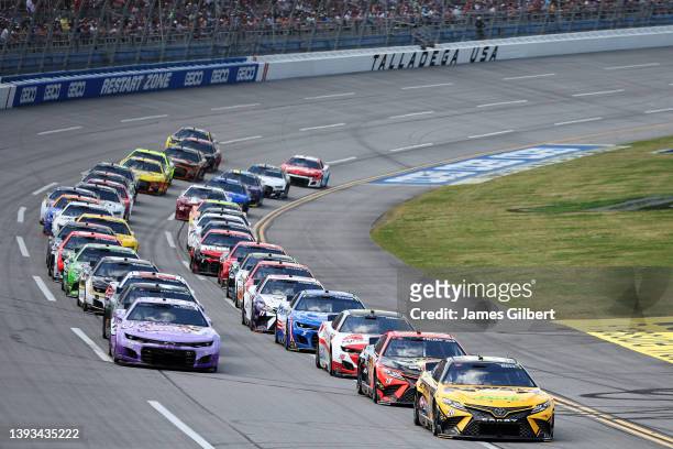 Christopher Bell, driver of the DeWalt Toyota, and Daniel Suarez, driver of the Tootsies Orchid Lounge Chevrolet, lead the field to start the NASCAR...