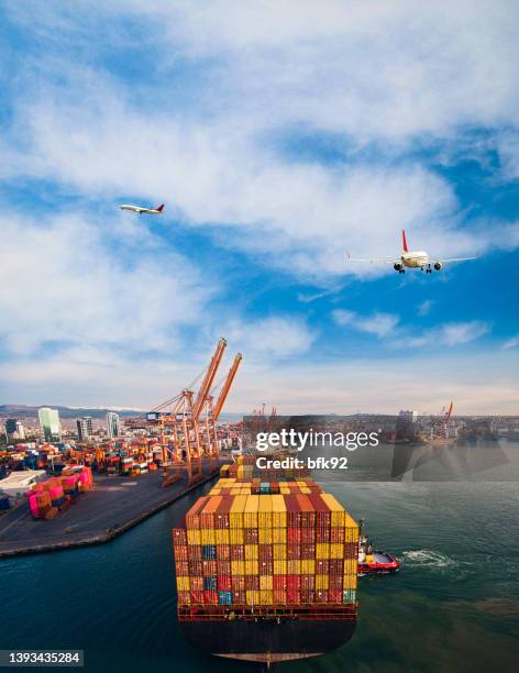 airplane flying above cargo ship. - air freight transportation stock pictures, royalty-free photos & images