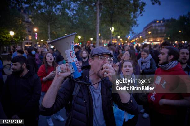 Parisians protest and chant against the election of France's centrist incumbent president Emmanuel Macron for a second five-year term as president at...