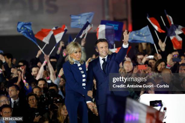 France's centrist incumbent president Emmanuel Macron stands with his wife Brigitte Macron after defeating his far-right rival Marine Le Pen for a...