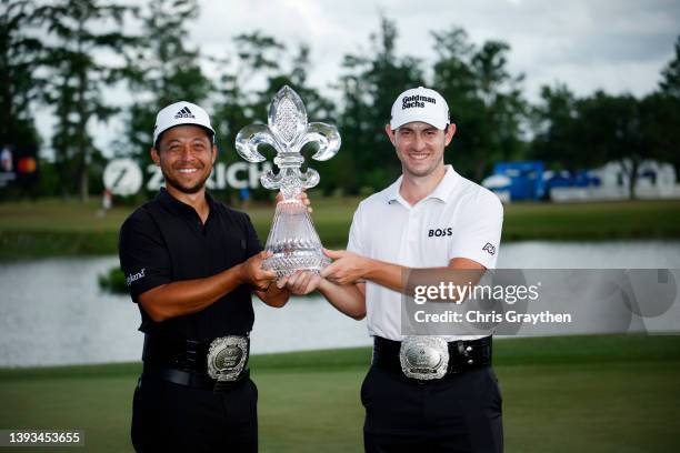 Xander Schauffele and Patrick Cantlay pose with the trophy after putting in to win on the 18th green during the final round of the Zurich Classic of...