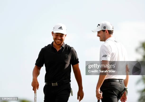 Xander Schauffele and Patrick Cantlay react after putting in to win on the 18th green during the final round of the Zurich Classic of New Orleans at...