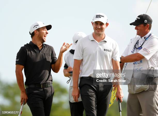 Xander Schauffele and Patrick Cantlay react after putting in to win on the 18th green during the final round of the Zurich Classic of New Orleans at...