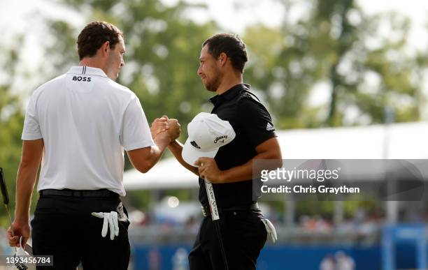 Xander Schauffele and Patrick Cantlay react after putting in to win on the 18th green during the final round of the Zurich Classic of New Orleans at...