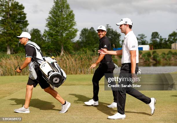 Xander Schauffele and Patrick Cantlay walk on the 18th green during the final round of the Zurich Classic of New Orleans at TPC Louisiana on April...