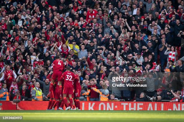 Liverpool players celebrate Andrew Robertson's goal in front of the Kop during the Premier League match between Liverpool and Everton at Anfield on...