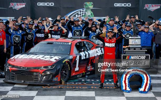 Ross Chastain, driver of the Moose Fraternity Chevrolet, and crew celebrate in victory lane after winning the NASCAR Cup Series GEICO 500 at...