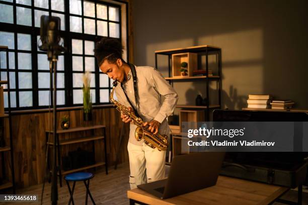 a male saxophonist playing - saxofoon stockfoto's en -beelden