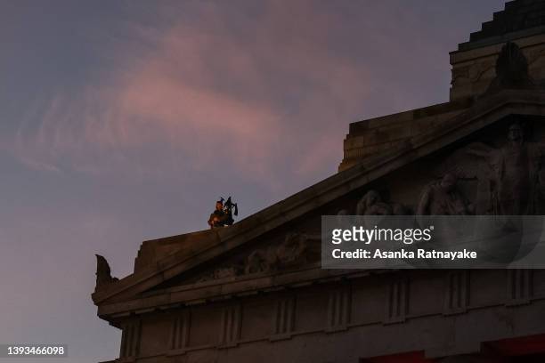 Man plays the bagpipes at the top of The Shrine of Remembrance on April 25, 2022 in Melbourne, Australia. Anzac day is a national holiday in...