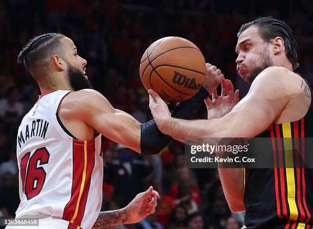 Caleb Martin of the Miami Heat and Danilo Gallinari of the Atlanta Hawks battle for a rebound during the first half in Game Four of the Eastern...