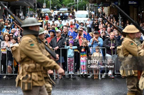Crowds watch as men in WWI army uniform march during an Anzac Day parade on April 25, 2022 in Brisbane, Australia. Anzac day is a national holiday in...