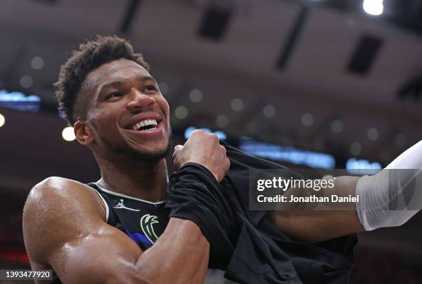 Giannis Antetokounmpo of the Milwaukee Bucks smiles as puts on a warm-up shirt near the end of Game Four of the Eastern Conference First Round...