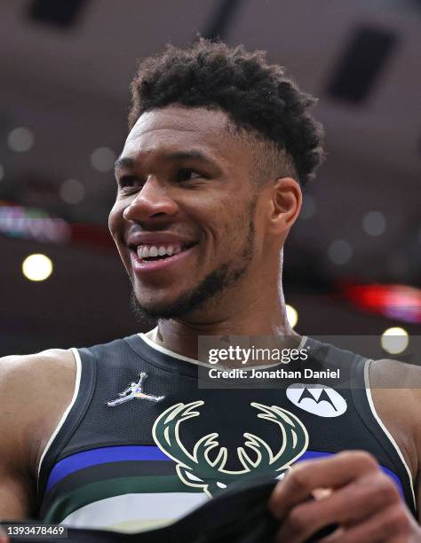 Giannis Antetokounmpo of the Milwaukee Bucks smiles at fans near the end of Game Four of the Eastern Conference First Round Playoffs against the...