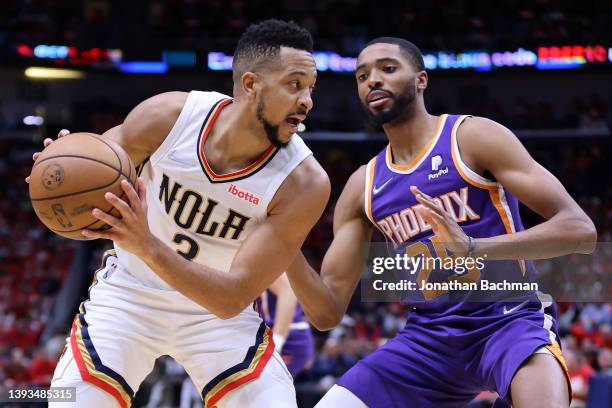 McCollum of the New Orleans Pelicans controls the ball against Mikal Bridges of the Phoenix Suns during the first half of Game Four of the Western...