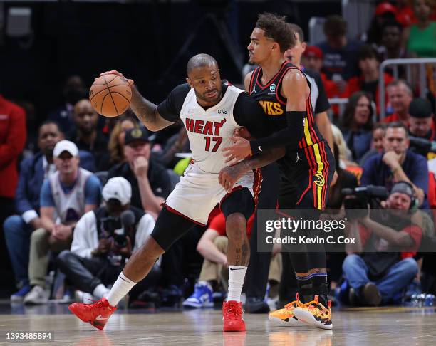 Tucker of the Miami Heat is defended by Trae Young of the Atlanta Hawks during the second half in Game Four of the Eastern Conference First Round at...