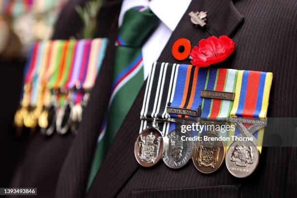 Service medal are displayed as war veterans, defence personnel and war widows make their way down Elizabeth Street during the ANZAC Day parade on...