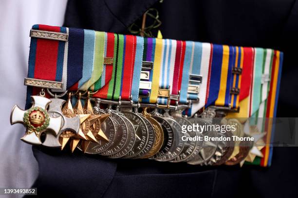 Service medal are displayed as war veterans, defence personnel and war widows make their way down Elizabeth Street during the ANZAC Day parade on...