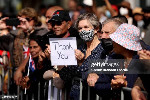 Member of the public holds a 'thank you' sign during the ANZAC Day parade on April 25, 2022 in Sydney, Australia. Anzac day is a national holiday in...