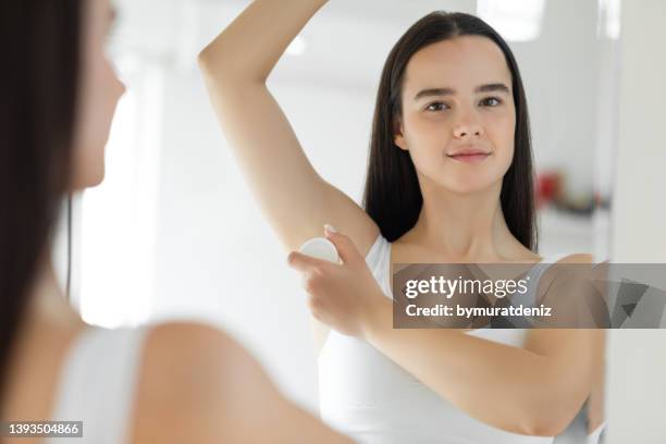 woman using roller deodorant - roll on bildbanksfoton och bilder