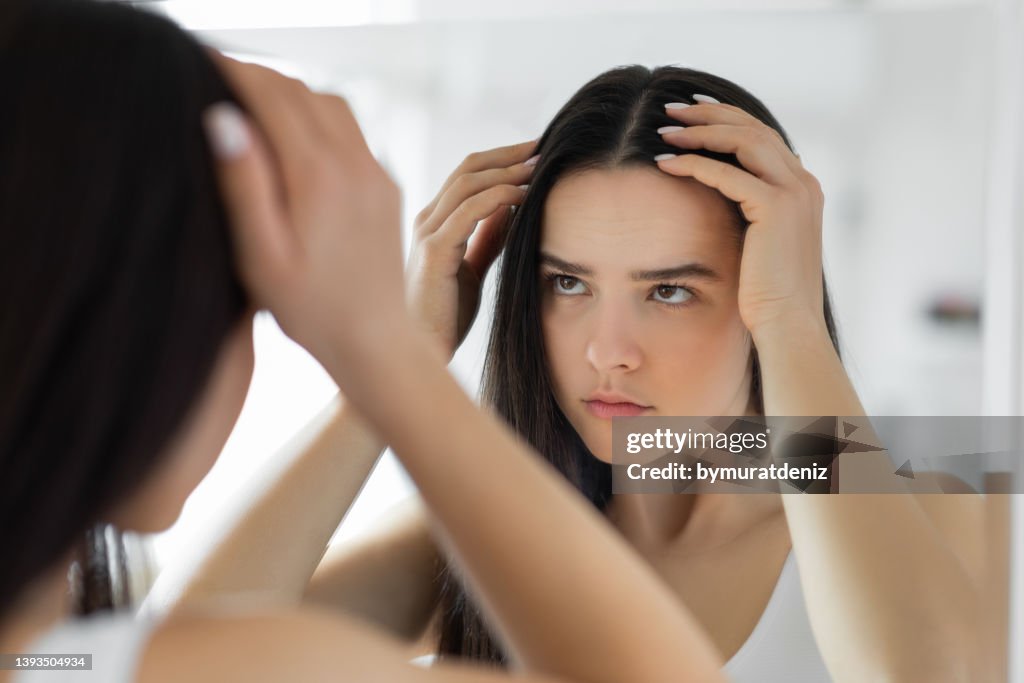 Femme ayant le problème avec la perte de cheveux