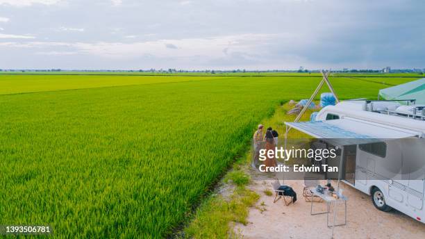 drone point of view asian chinese gay couple enjoying with friends beside motor home campervan - paddy field stock pictures, royalty-free photos & images
