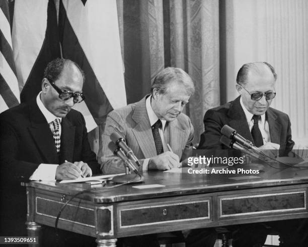Egyptian politician Anwar Sadat , president of Egypt, American politician Jimmy Carter, and Israeli politician Menachem Begin , Prime Minister of...
