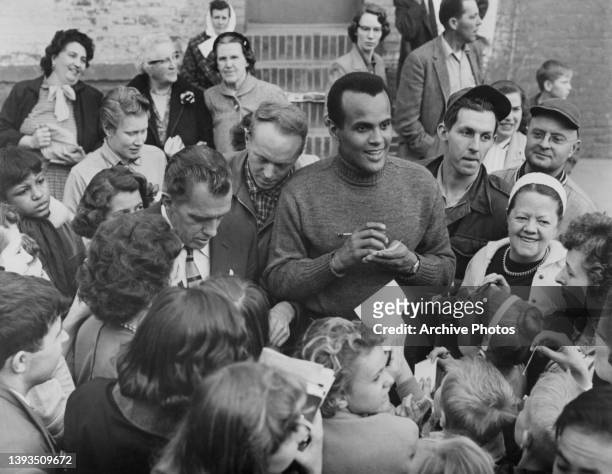American television personality, reporter and impresario Ed Sullivan and American singer-songwriter and civil rights activist Harry Belafonte signing...